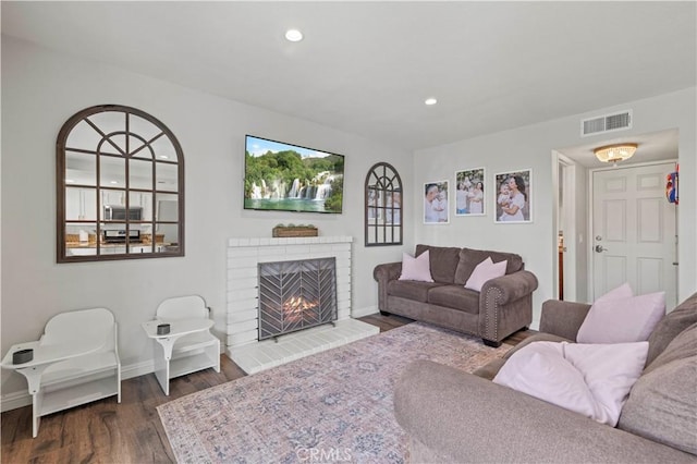 28032 Nantucket St, Castaic, CA 91384 - living area featuring dark wood-style flooring, a brick fireplace, and recessed lighting