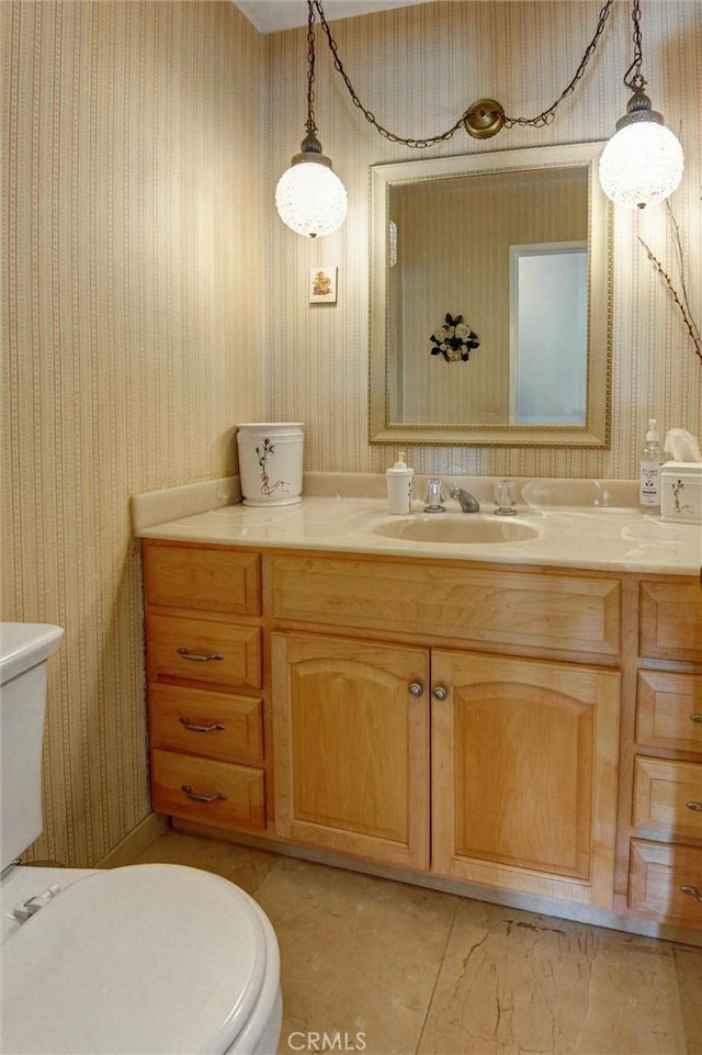 872 Deborah St, Upland, CA 91784 - bathroom featuring wallpapered walls, vanity, and marble look tile flooring