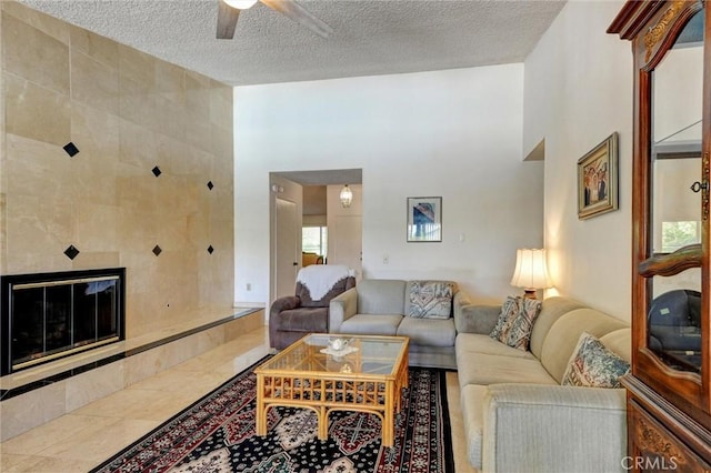 872 Deborah St, Upland, CA 91784 - tiled living room featuring a ceiling fan, a textured ceiling, and a fireplace