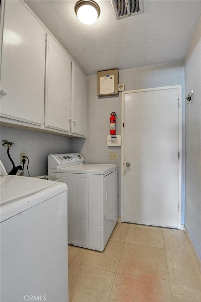 872 Deborah St, Upland, CA 91784 - laundry room with cabinet space, washing machine and clothes dryer, and light tile patterned floors
