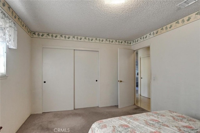 872 Deborah St, Upland, CA 91784 - bedroom with light carpet, a textured ceiling, and a closet