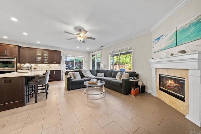 9141 Meadowrun Ct, San Diego, CA 92129 - living area with a ceiling fan, a tiled fireplace, ornamental molding, and recessed lighting