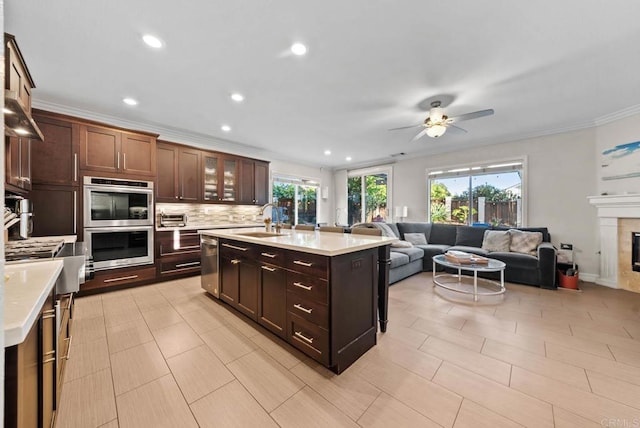 9141 Meadowrun Ct, San Diego, CA 92129 - kitchen featuring appliances with stainless steel finishes, light countertops, decorative backsplash, open floor plan, and a ceiling fan