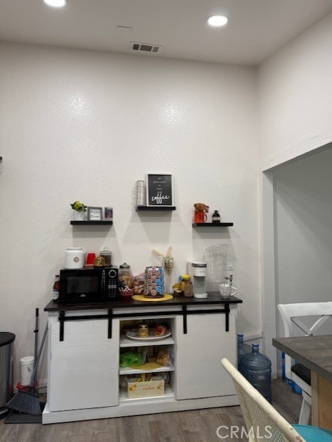 12446 Mount Baldy Dr, Victorville, CA 92392 - bar with wood finished floors, black microwave, and recessed lighting
