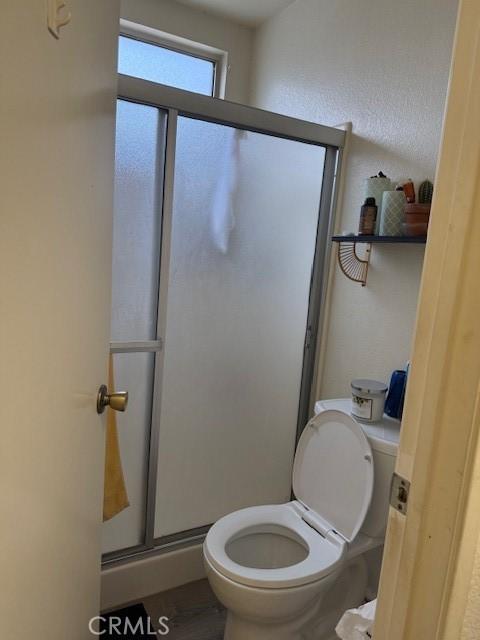 12446 Mount Baldy Dr, Victorville, CA 92392 - full bathroom featuring a shower stall and wood finished floors