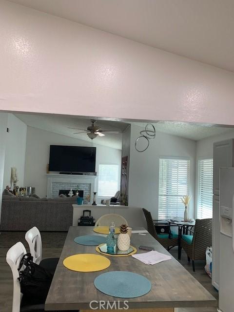 12446 Mount Baldy Dr, Victorville, CA 92392 - dining area with a ceiling fan, a fireplace, and plenty of natural light