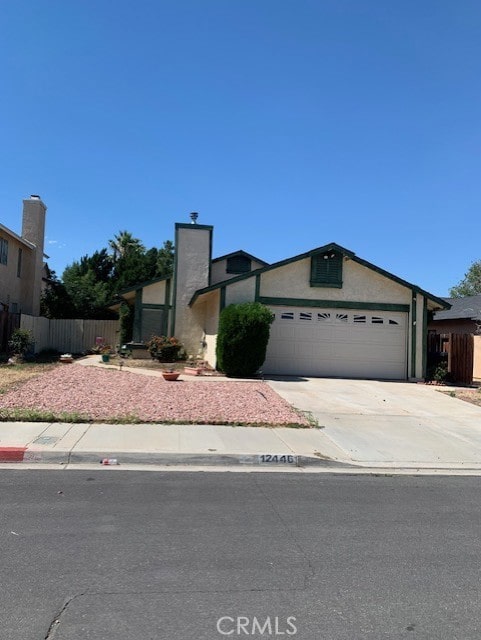 12446 Mount Baldy Dr, Victorville, CA 92392 - view of front of house with driveway, an attached garage, and stucco siding