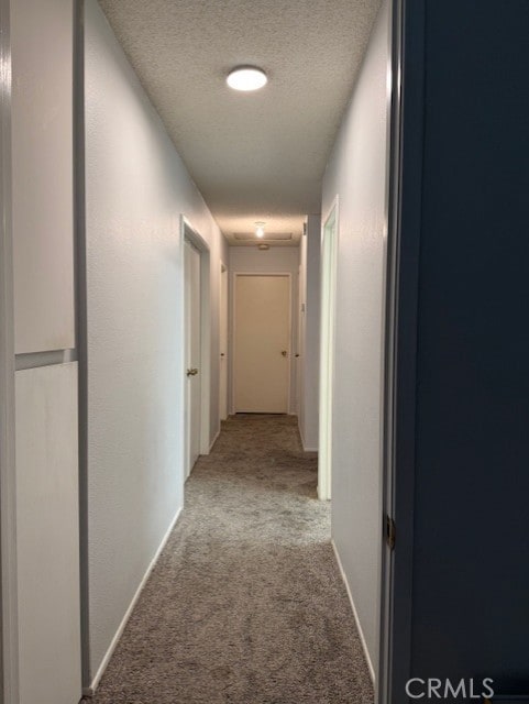 12446 Mount Baldy Dr, Victorville, CA 92392 - hallway featuring carpet floors and a textured ceiling