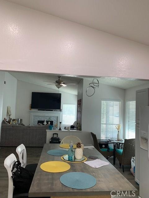 12446 Mount Baldy Dr, Victorville, CA 92392 - dining area featuring ceiling fan, a fireplace, and plenty of natural light
