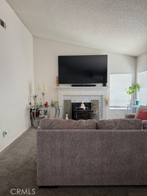 12446 Mount Baldy Dr, Victorville, CA 92392 - carpeted living room featuring a brick fireplace, vaulted ceiling, and a textured ceiling