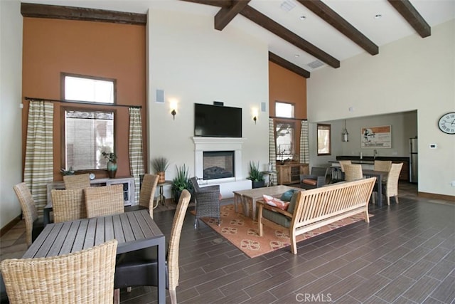 760 S Olive St, Anaheim, CA 92805 - living area with high vaulted ceiling, beamed ceiling, a fireplace, and wood finished floors