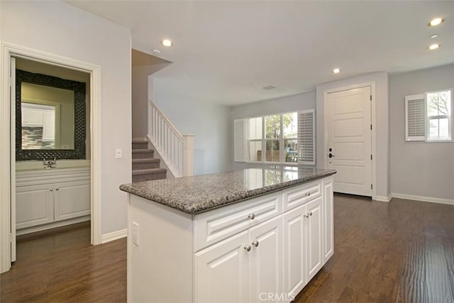760 S Olive St, Anaheim, CA 92805 - kitchen with recessed lighting, stone counters, healthy amount of natural light, white cabinets, and dark wood finished floors