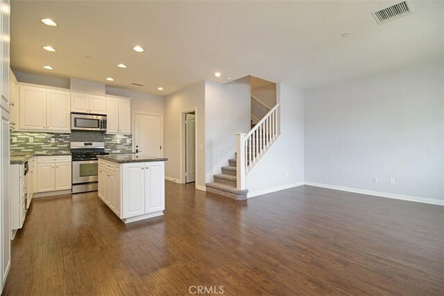 760 S Olive St, Anaheim, CA 92805 - kitchen featuring stainless steel appliances, a kitchen island, dark wood finished floors, dark countertops, and tasteful backsplash