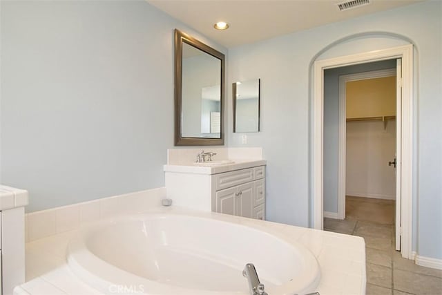 760 S Olive St, Anaheim, CA 92805 - full bathroom with vanity, a garden tub, tile patterned flooring, a walk in closet, and recessed lighting