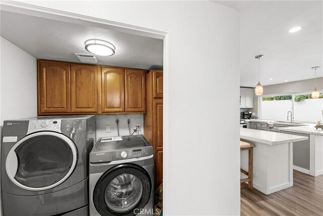 2040 Cape Cod Ct, Claremont, CA 91711 - washroom featuring washing machine and dryer and light wood finished floors