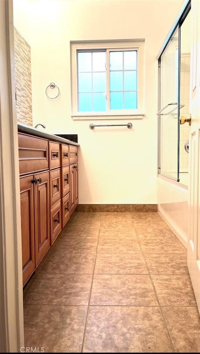 8049 Le Berthon St, Sunland, CA 91040 - full bathroom with vanity, tile patterned floors, and bath / shower combo with glass door