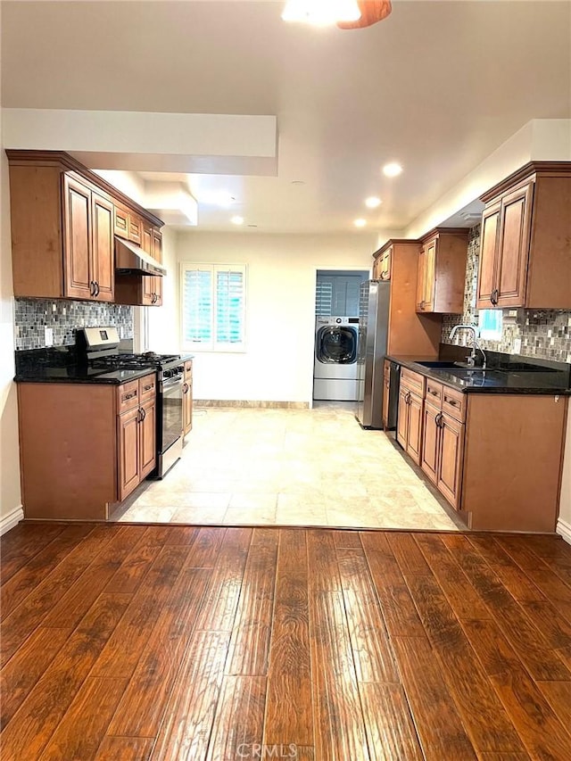 8049 Le Berthon St, Sunland, CA 91040 - kitchen featuring stainless steel appliances, washer / clothes dryer, under cabinet range hood, light wood-type flooring, and dark countertops