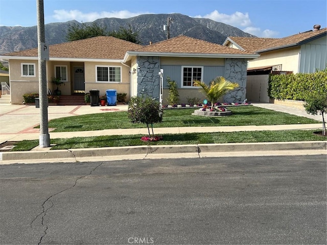 8049 Le Berthon St, Sunland, CA 91040 - ranch-style home with a mountain view, stone siding, driveway, an attached garage, and a front lawn