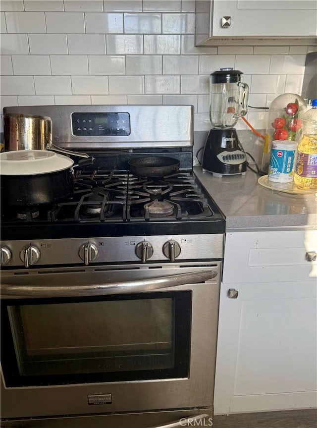 4041 Eagle St, Los Angeles, CA 90063 - kitchen with gas range, tasteful backsplash, light countertops, and white cabinets