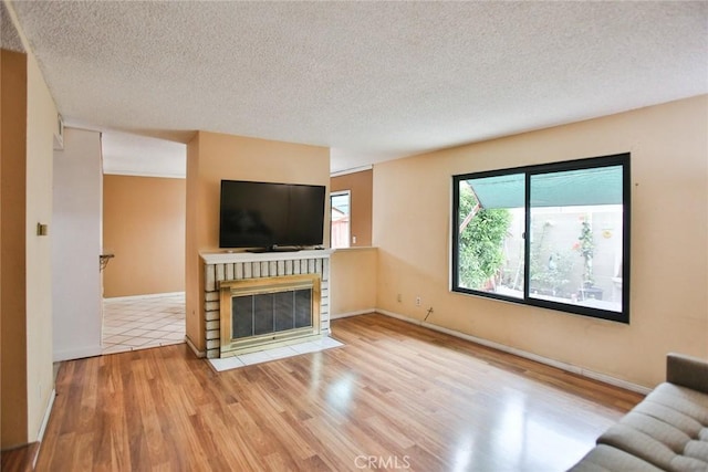 8458 Evergreen, Garden Grove, CA 92841 - unfurnished living room with a textured ceiling, a fireplace, and wood finished floors