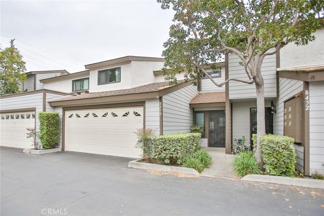 8458 Evergreen, Garden Grove, CA 92841 - townhome / multi-family property with a garage, a shingled roof, and driveway