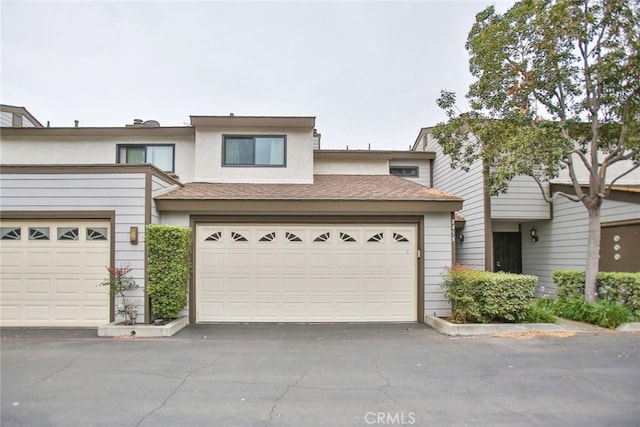 8458 Evergreen, Garden Grove, CA 92841 - townhome / multi-family property featuring a garage, asphalt driveway, and stucco siding