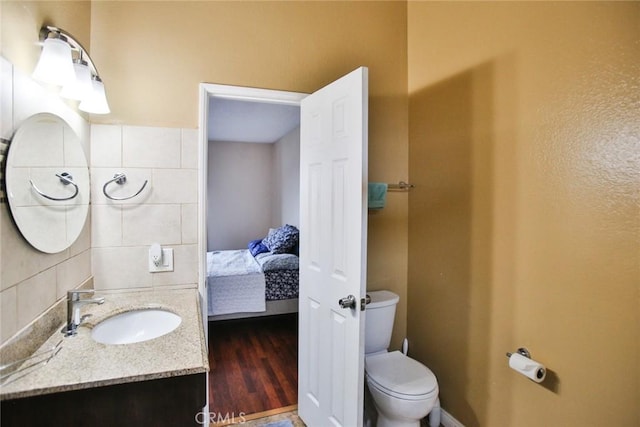 8458 Evergreen, Garden Grove, CA 92841 - bathroom with vanity, ensuite bathroom, tasteful backsplash, and wood finished floors