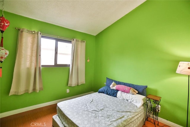 8458 Evergreen, Garden Grove, CA 92841 - bedroom featuring a textured ceiling, wood finished floors, and lofted ceiling