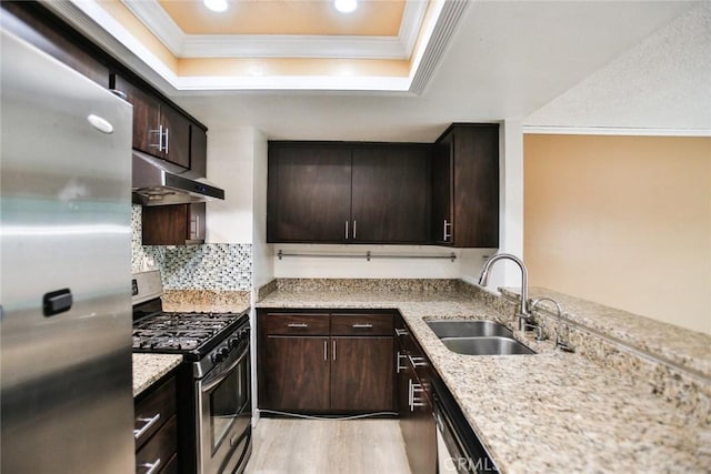 8458 Evergreen, Garden Grove, CA 92841 - kitchen with stainless steel appliances, under cabinet range hood, crown molding, a tray ceiling, and light wood finished floors