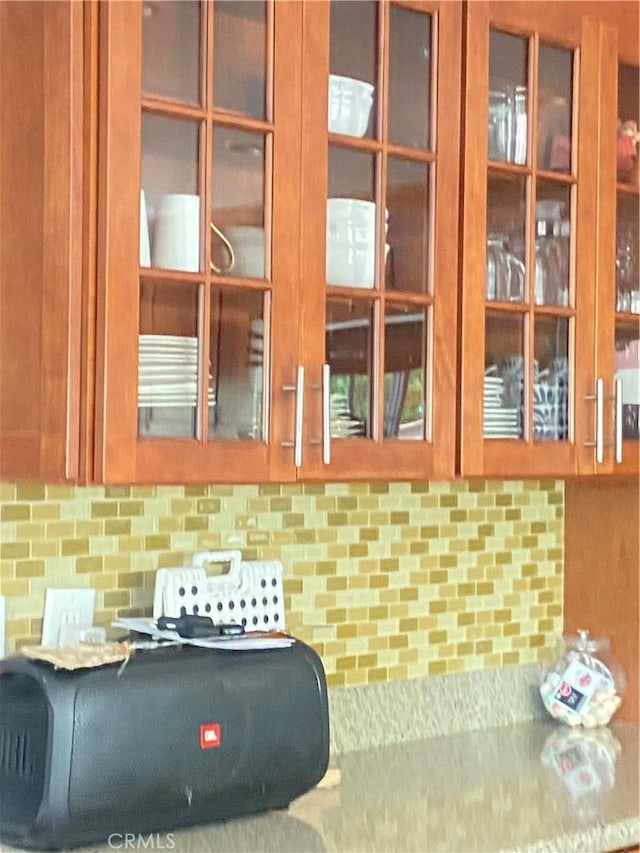 9849 Canada Way, Riverside, CA 92503 - detailed view of glass insert cabinets, decorative backsplash, and brown cabinets