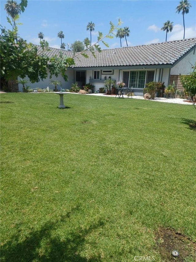 9849 Canada Way, Riverside, CA 92503 - rear view of house with a tiled roof, stucco siding, and a yard