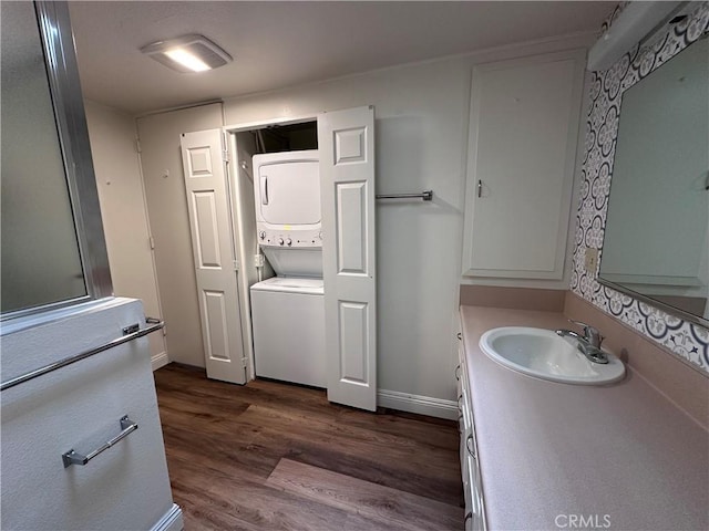 1271 Kenwood Unit 163D, Seal Beach, CA 90740 - bathroom featuring stacked washer / drying machine, wood finished floors, and vanity