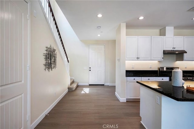 30316 Slate St, Murrieta, CA 92563 - kitchen with under cabinet range hood, wood finished floors, white cabinetry, recessed lighting, and stainless steel stove