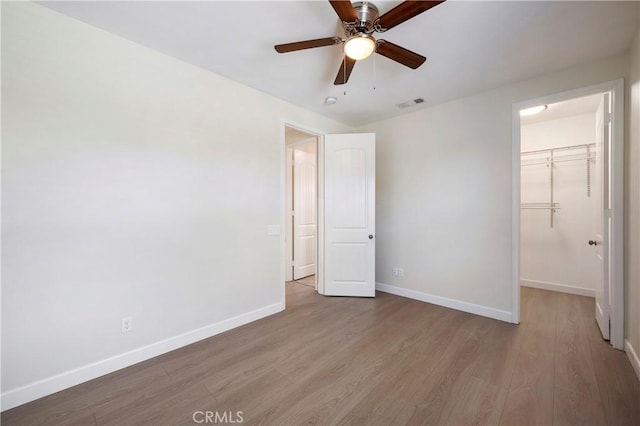 30316 Slate St, Murrieta, CA 92563 - unfurnished bedroom with wood finished floors, a walk in closet, a closet, and ceiling fan