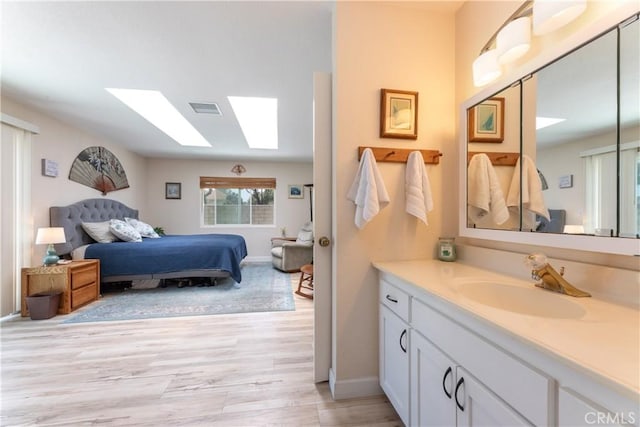 10262 Circulo De Juarez, Fountain Valley, CA 92708 - bathroom with a skylight, wood finished floors, vanity, and ensuite bathroom