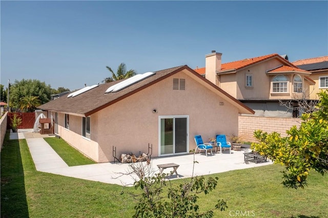10262 Circulo De Juarez, Fountain Valley, CA 92708 - back of house featuring stucco siding, a patio area, solar panels, and a chimney
