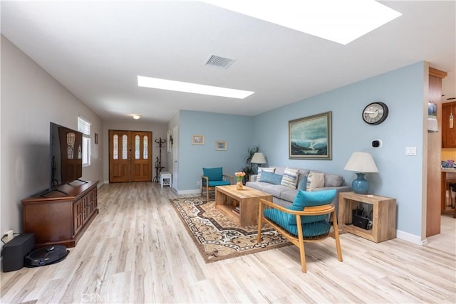 10262 Circulo De Juarez, Fountain Valley, CA 92708 - living room featuring a skylight and light wood finished floors