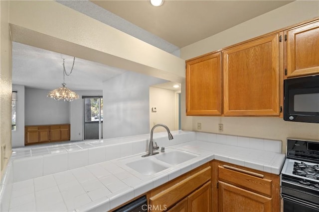 1441 Brett Pl Unit 148, San Pedro, CA 90732 - kitchen with range with gas cooktop, black microwave, light countertops, a chandelier, and brown cabinets