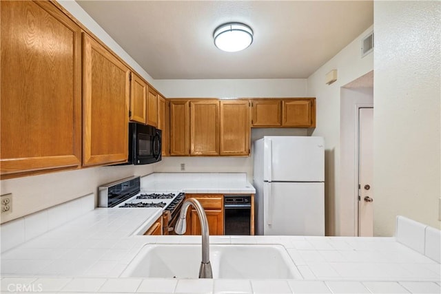 1441 Brett Pl Unit 148, San Pedro, CA 90732 - kitchen featuring white appliances, tile counters, and brown cabinets