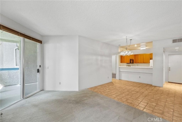 1441 Brett Pl Unit 148, San Pedro, CA 90732 - unfurnished living room with a textured ceiling, a chandelier, and light colored carpet