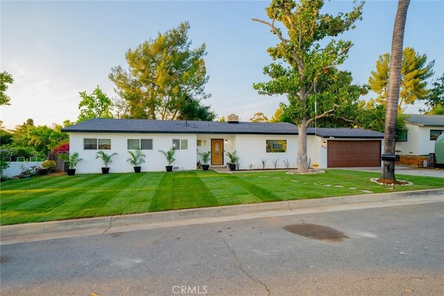 533 Via Vista Dr, Redlands, CA 92373 - single story home with concrete driveway, a front lawn, an attached garage, and stucco siding