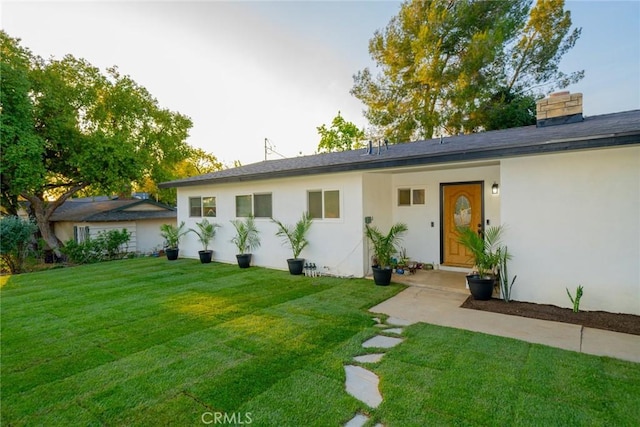 533 Via Vista Dr, Redlands, CA 92373 - ranch-style house featuring a front yard, stucco siding, and a chimney