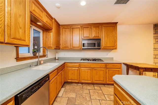 533 Via Vista Dr, Redlands, CA 92373 - kitchen with appliances with stainless steel finishes, recessed lighting, stone tile flooring, brown cabinets, and light countertops