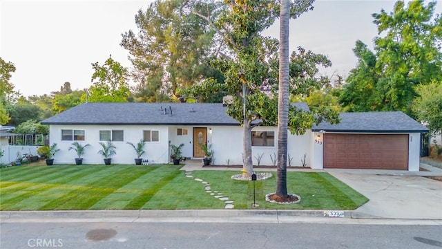 533 Via Vista Dr, Redlands, CA 92373 - ranch-style house with concrete driveway, a front yard, stucco siding, and a garage