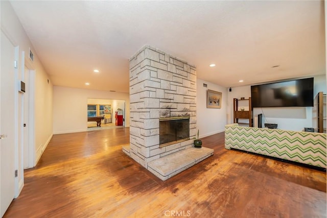 533 Via Vista Dr, Redlands, CA 92373 - living room featuring wood finished floors, a stone fireplace, and recessed lighting