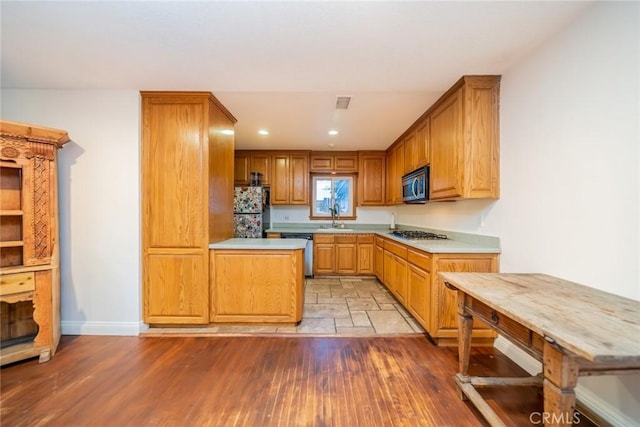 533 Via Vista Dr, Redlands, CA 92373 - kitchen with appliances with stainless steel finishes, light countertops, recessed lighting, and brown cabinetry