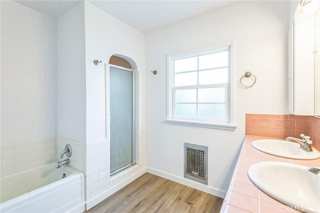 5516 Palm Ave, Whittier, CA 90601 - full bathroom with wood finished floors, a bath, a stall shower, double vanity, and backsplash