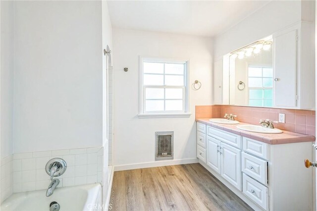 5516 Palm Ave, Whittier, CA 90601 - full bathroom featuring healthy amount of natural light, double vanity, a garden tub, and tasteful backsplash