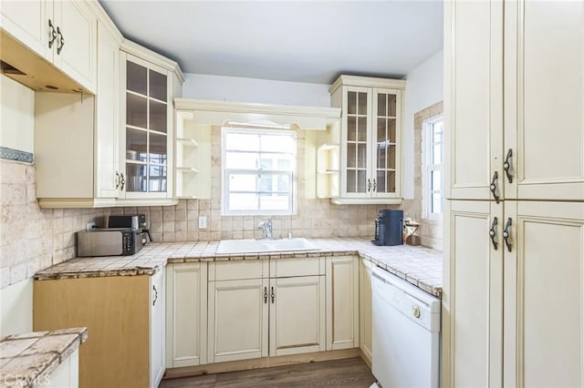 5516 Palm Ave, Whittier, CA 90601 - kitchen featuring dishwasher, backsplash, light countertops, and glass insert cabinets