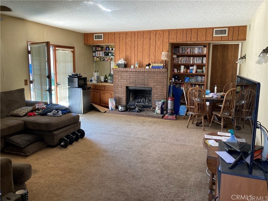 18708 Fieldbrook St, Rowland Heights, CA 91748 - carpeted living area with a textured ceiling, wooden walls, and a fireplace